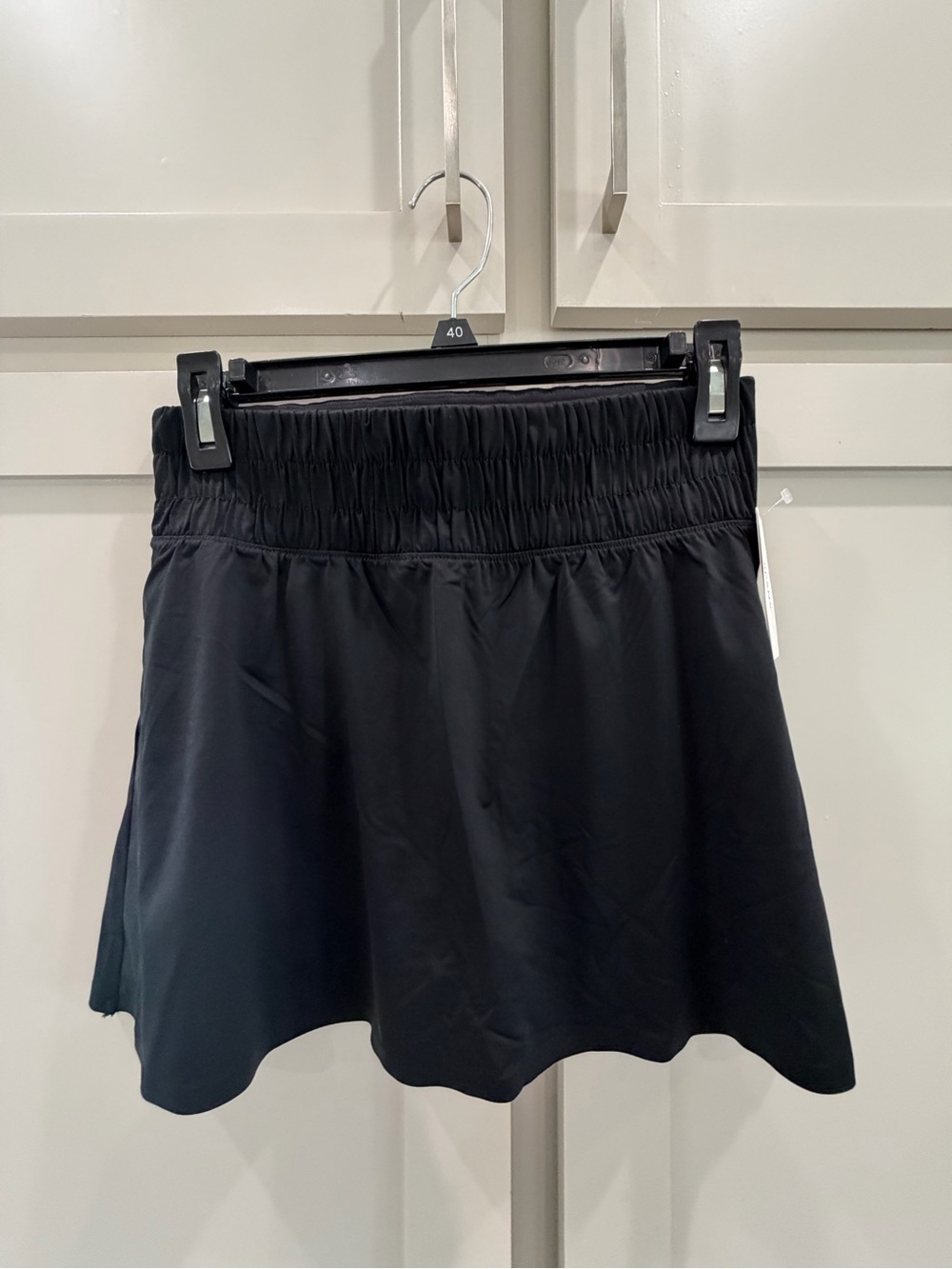 SPANX Black Booty Boost Skort with hidden shorts and pockets